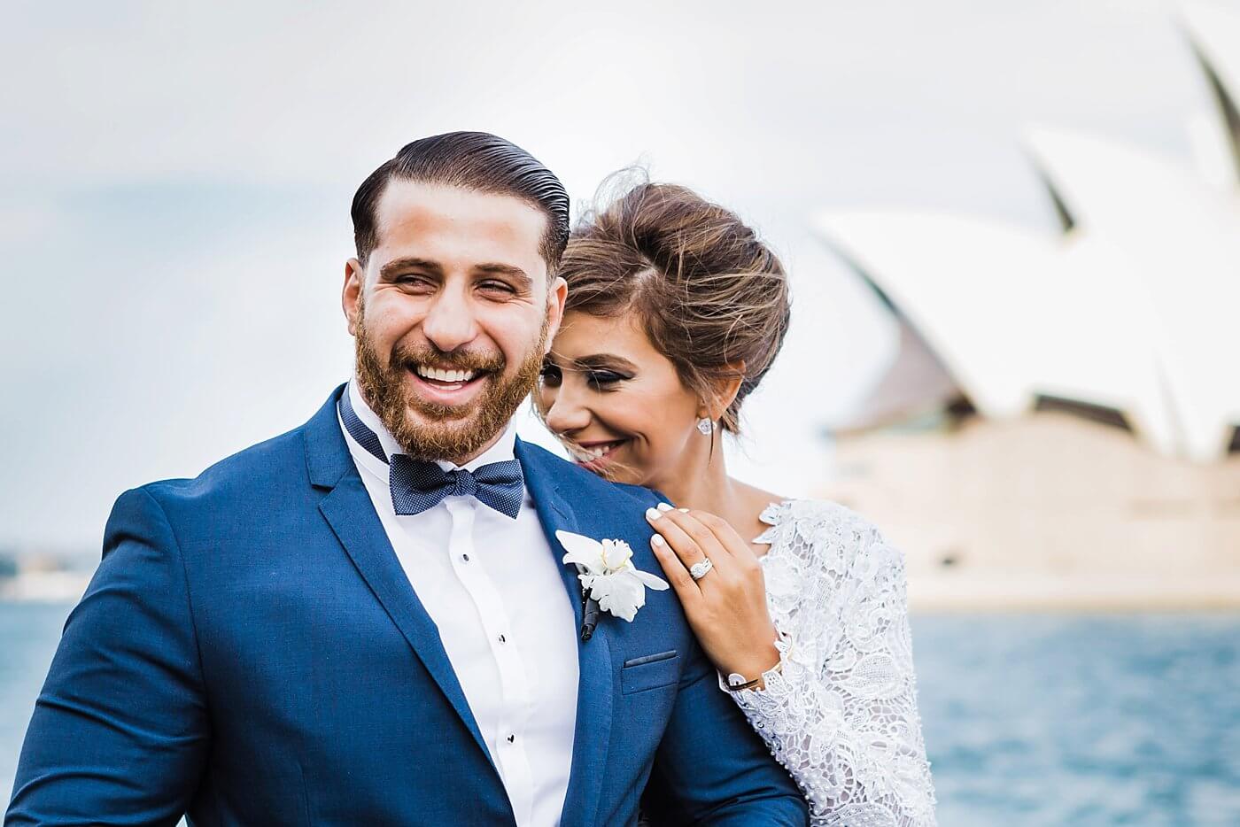 Bride and groom at Dawe's Point in front of the Sydney Opera House share a special moment during their wedding portraits. - Photo taken in Sydney Australia by Dylan Martin Photography - London Ontario Wedding Photographer