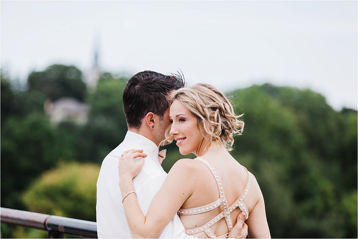 Gorgeous bride portrait with groom on the bridge overlooking a forest - Woodstock London Ontario Wedding Photographer - Dylan Martin Photography
