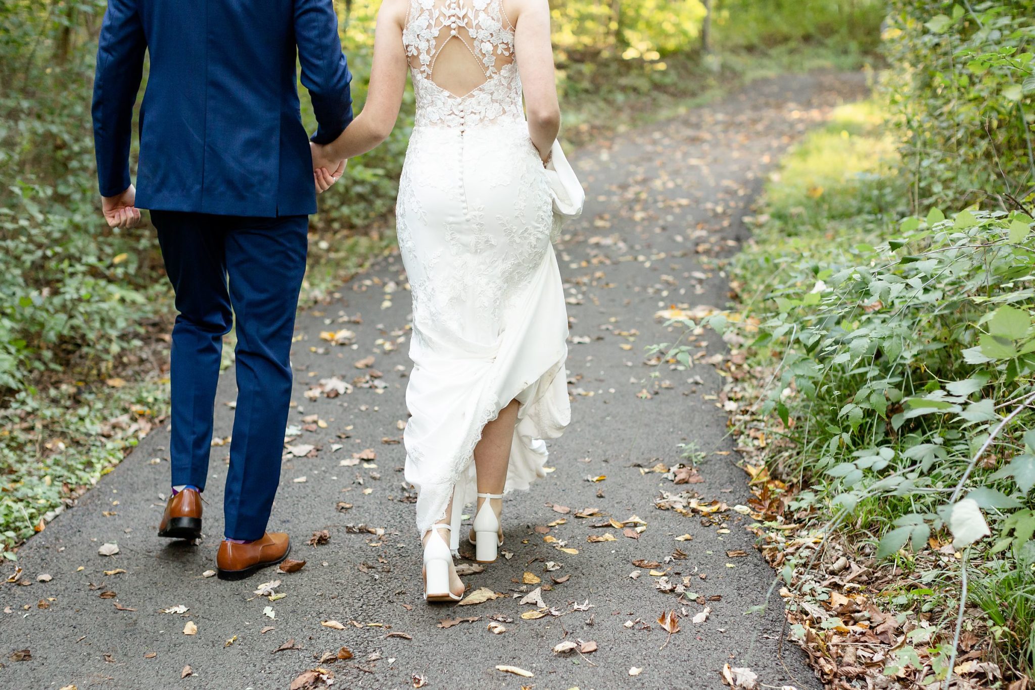 Bride and groom walking back to Windermere Manor for their wedding reception